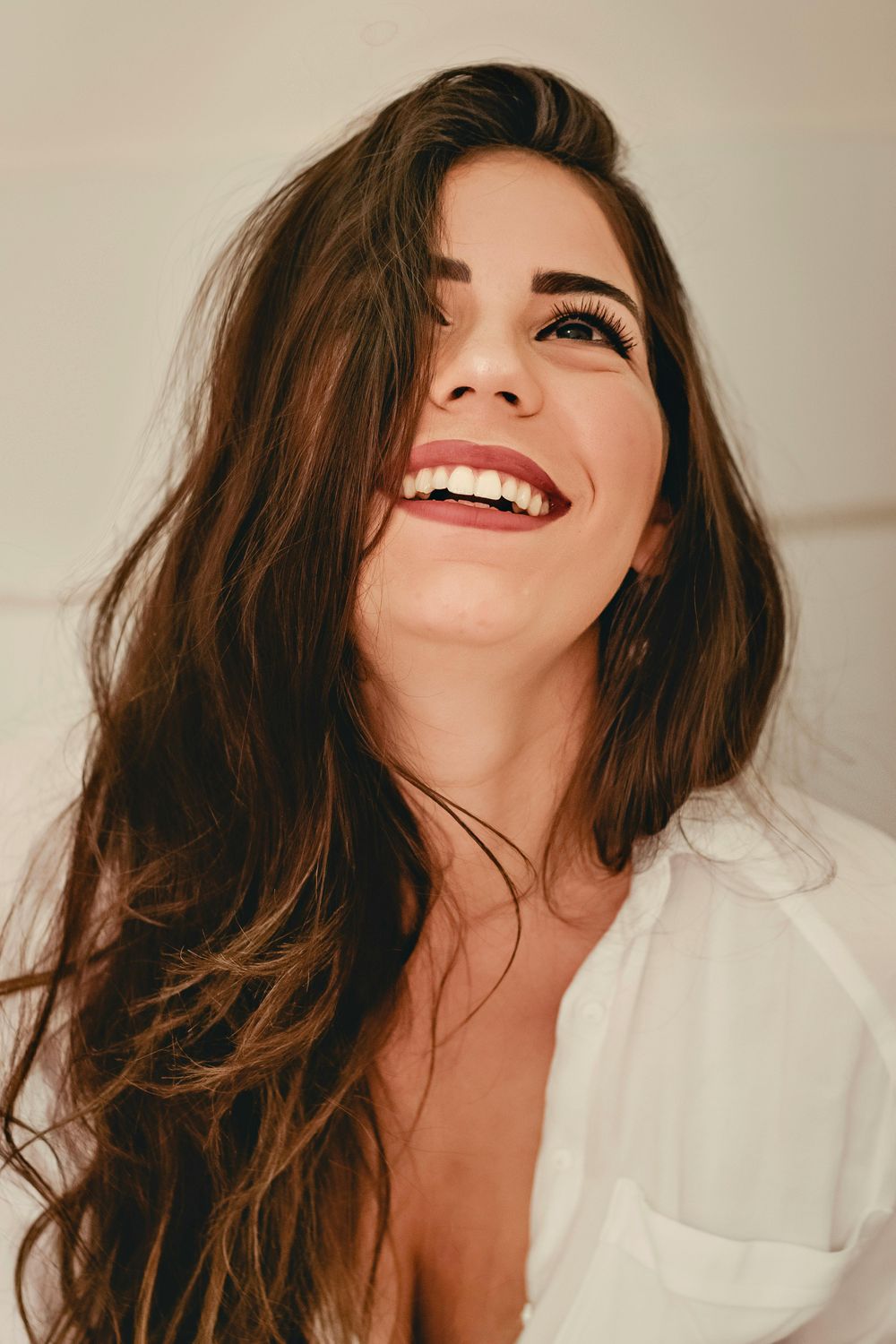 Smiling woman with long, flowing hair.